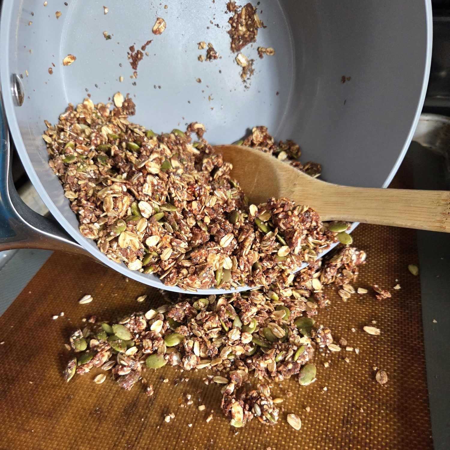 Pour granola onto baking sheet
