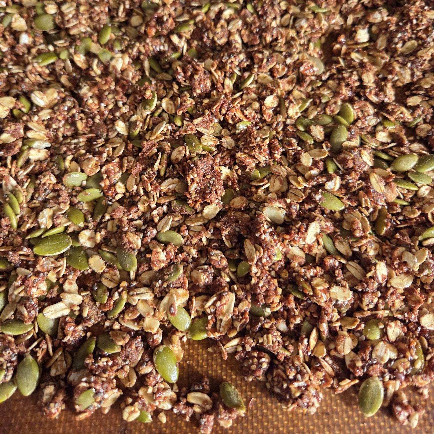 Spread granola on baking tray with parchment paper or a baking mat