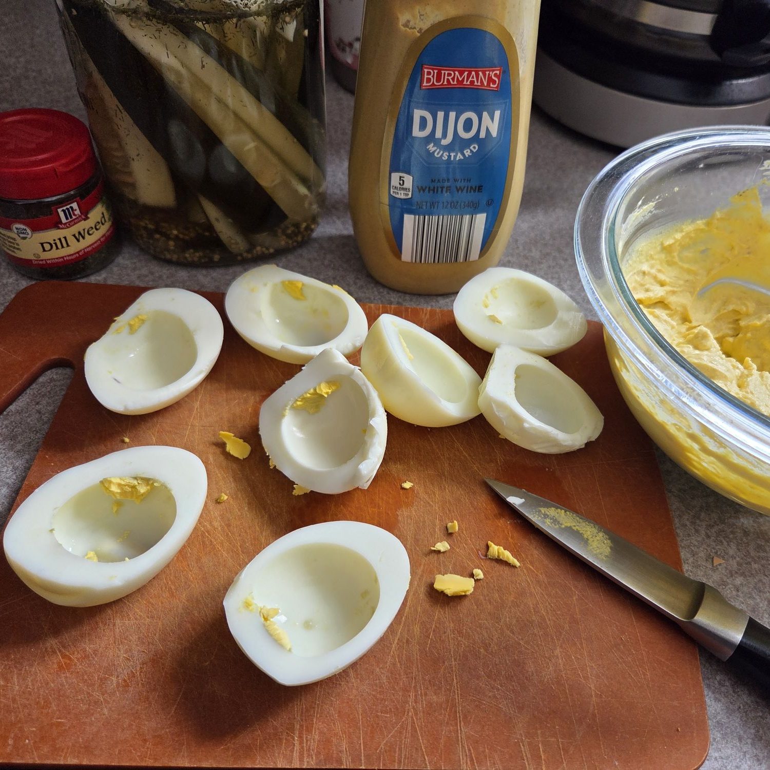 Four halved hard-boiled eggs with yolks removed
